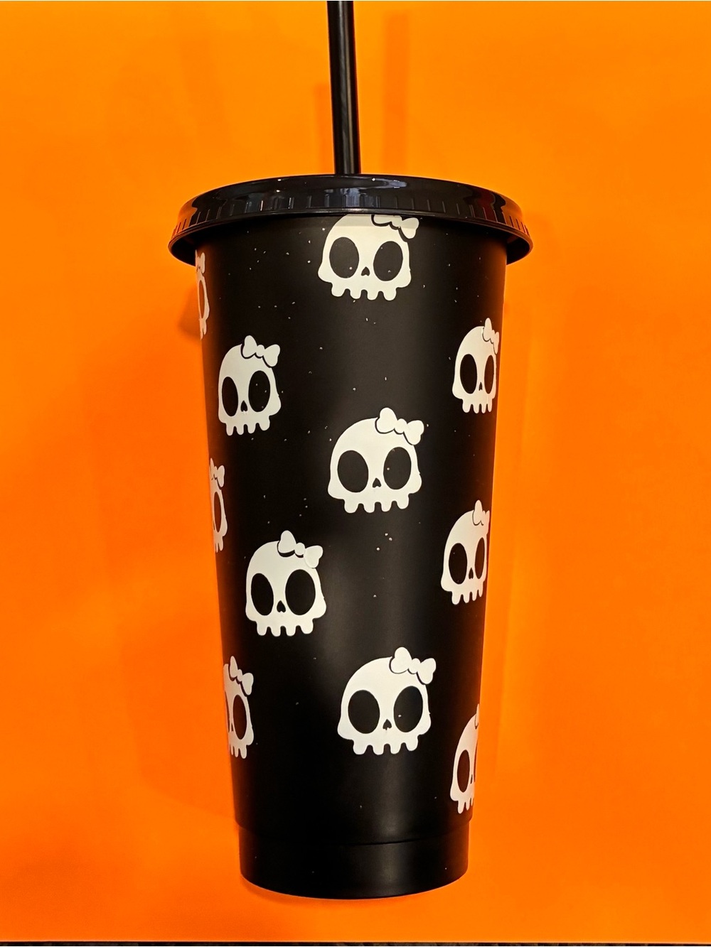 Homemade tumbler with glow in the dark skulls with bows
